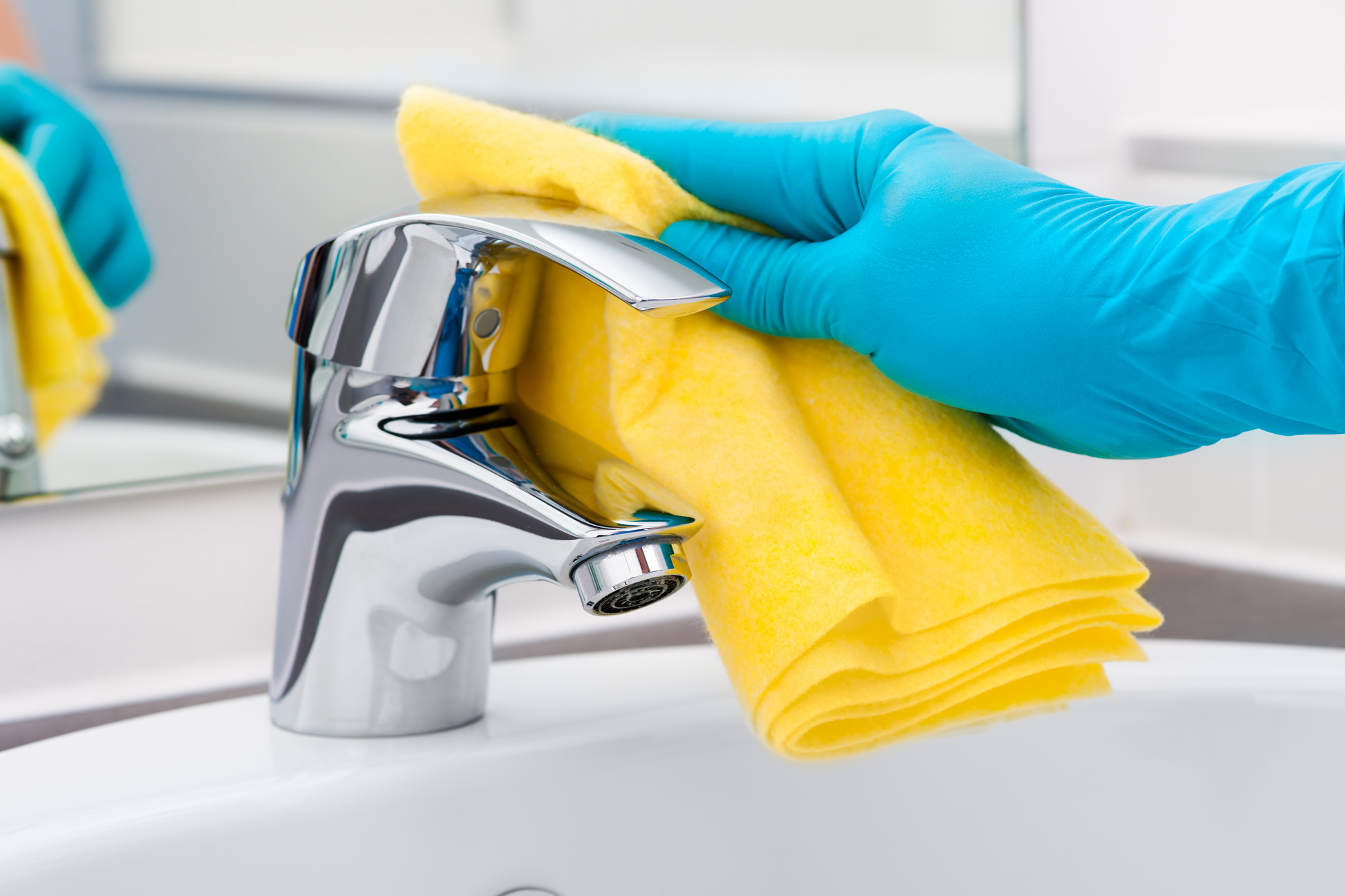 using our Shine bathroom cleaner to clean taps