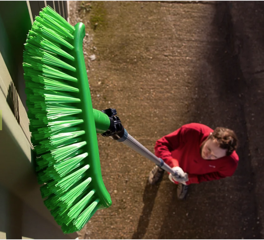 close up of a telescopic broom being used showing the broom head