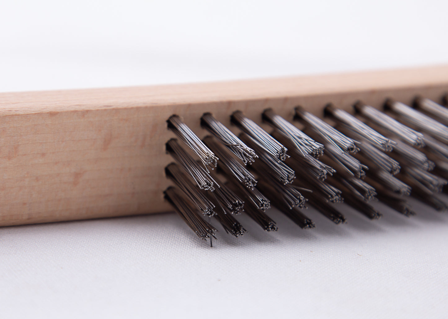 4 rows of bristles on the wire brush with curved handle