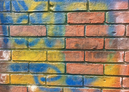 photo showing a wall treated with our anti graffiti paint and clean brickwork after cleaning